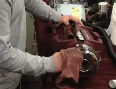 Vacuum repair technician cleaning and servicing a vacuum motor in Lowell, MA